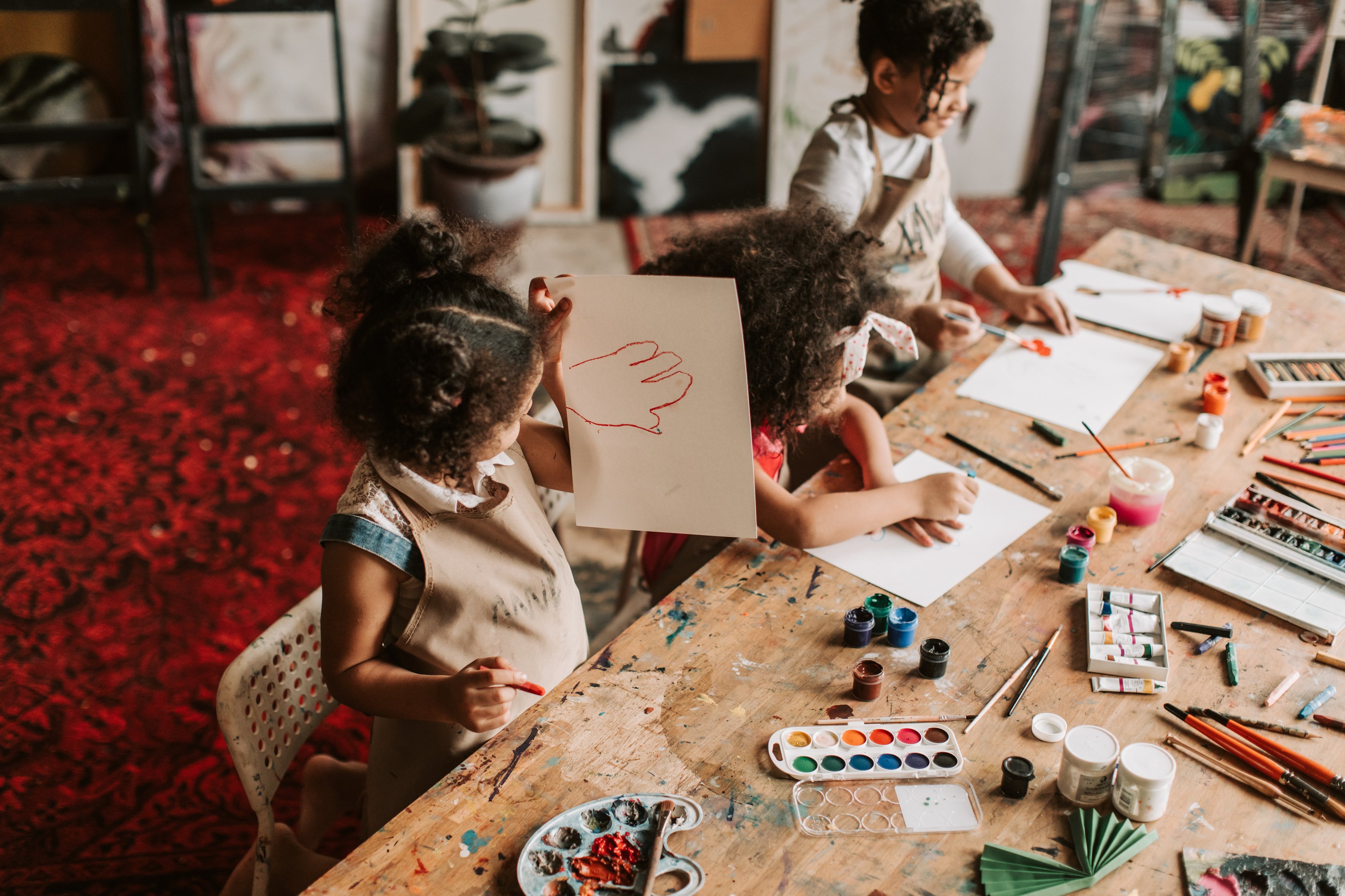 Girls Paints at the Table in Art School